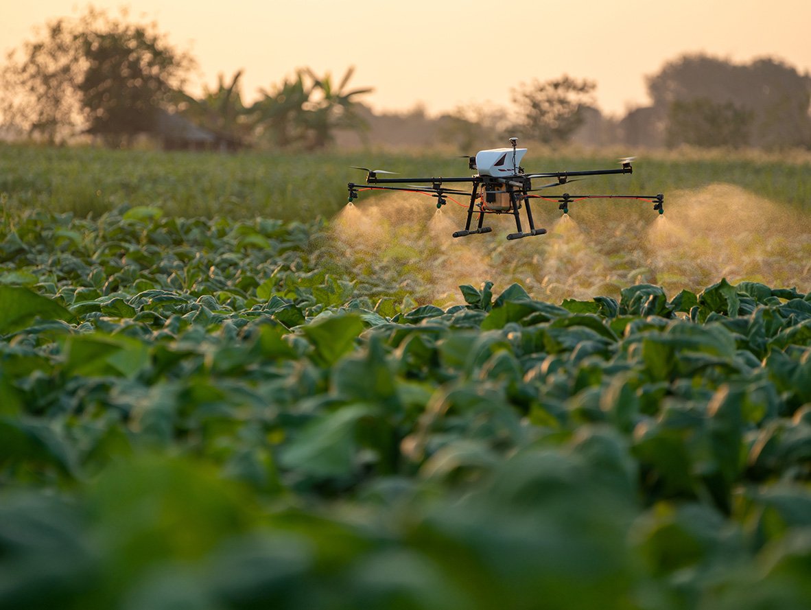 Drone spraying a field